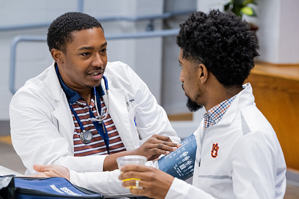 student at the AU Medical Clinic receiving care from a practitioner