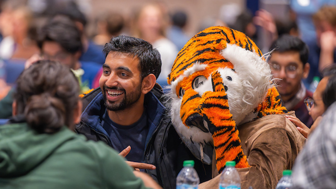 Aubie and student posing at the Peace Dinner